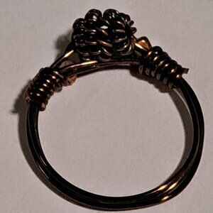 copper brown color wire ring with 3 wire swirls on the top
